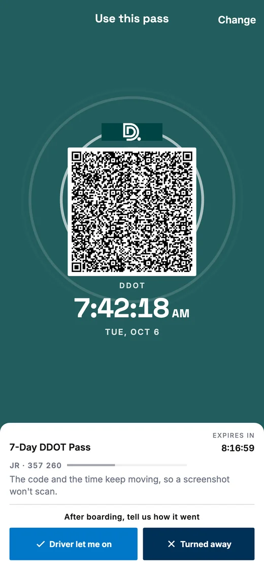 A DDOT pass ready to scan: the barcode on a white tile in the middle of the coloured screen, with the clock below it