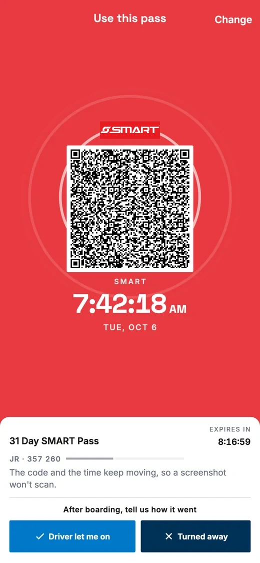 A SMART pass ready to scan: the barcode on a white tile in the middle of the coloured screen, with the clock below it